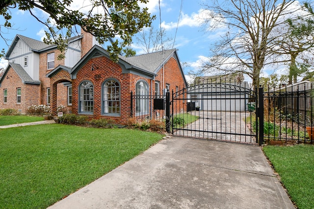 view of front facade featuring a front yard, a gate, fence, a chimney, and brick siding