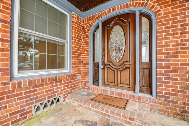 property entrance featuring brick siding