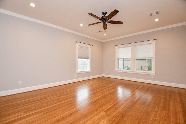 spare room featuring visible vents, ornamental molding, recessed lighting, light wood finished floors, and baseboards