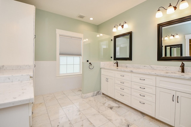 full bathroom with double vanity, visible vents, marble finish floor, and a sink