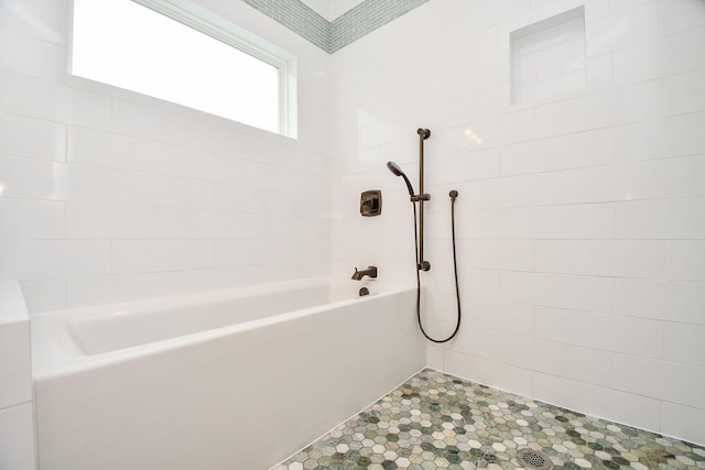 bathroom featuring a bathing tub and tiled shower