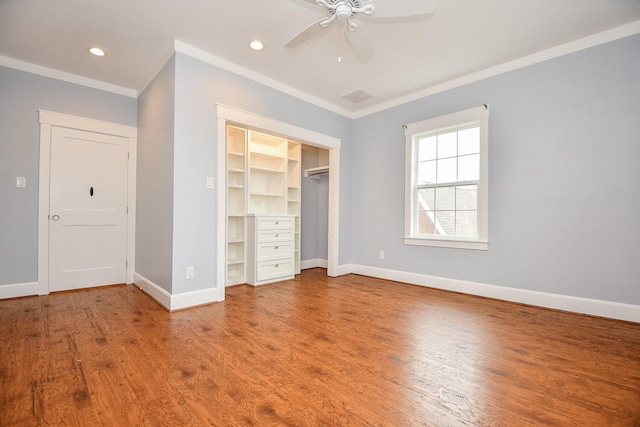 unfurnished bedroom featuring ornamental molding, wood finished floors, recessed lighting, a closet, and baseboards