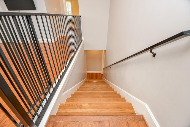 stairs featuring baseboards and wood finished floors