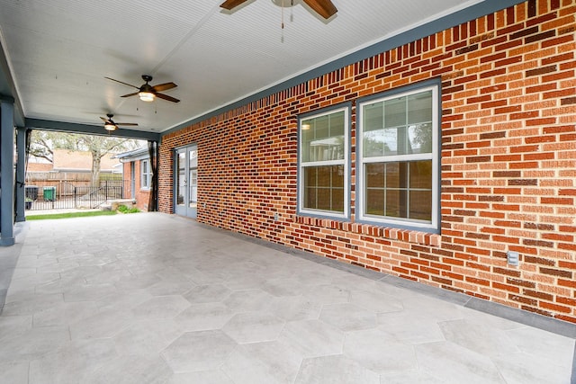 view of patio featuring ceiling fan and fence