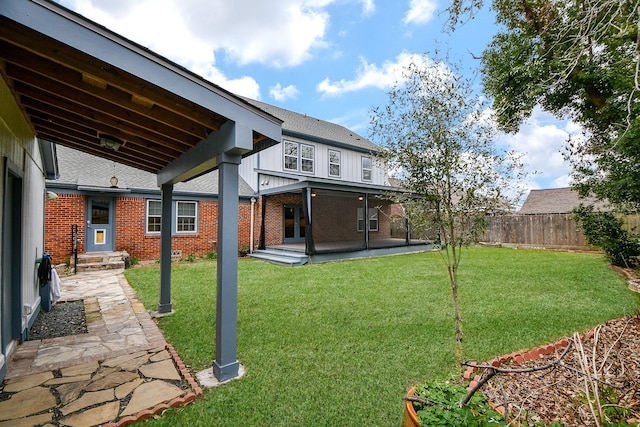 view of yard featuring a patio, entry steps, and fence