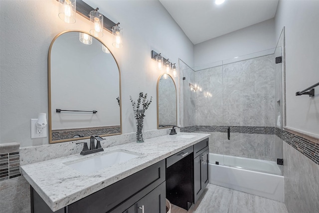 bathroom with a sink, shower / bathtub combination, and double vanity