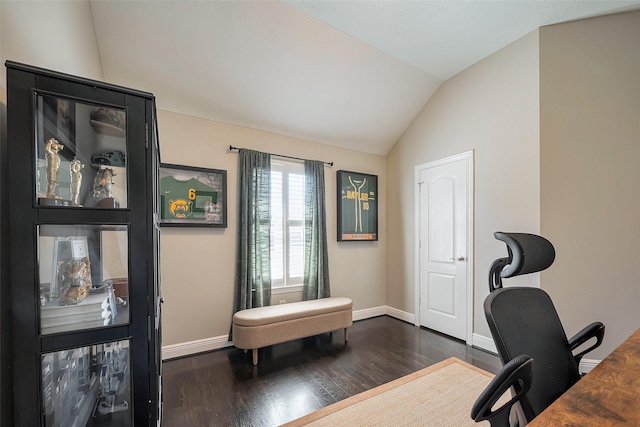 office space featuring dark wood-type flooring, lofted ceiling, and baseboards