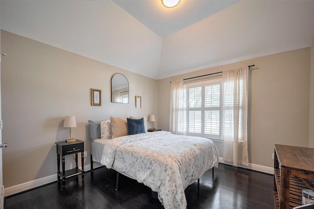 bedroom featuring dark wood-style floors, baseboards, and vaulted ceiling