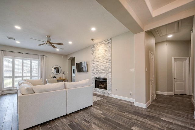 living room with attic access, baseboards, visible vents, dark wood-style flooring, and a fireplace