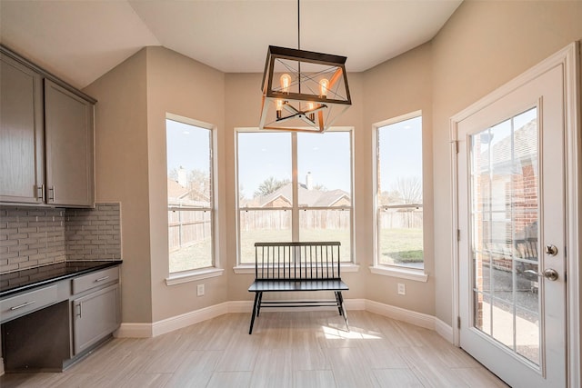 dining area featuring baseboards and an inviting chandelier