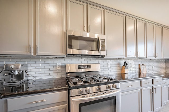 kitchen with stainless steel appliances and tasteful backsplash