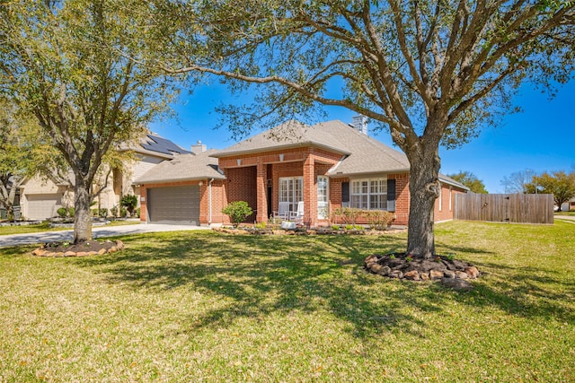 ranch-style house featuring a garage, a front yard, concrete driveway, and brick siding