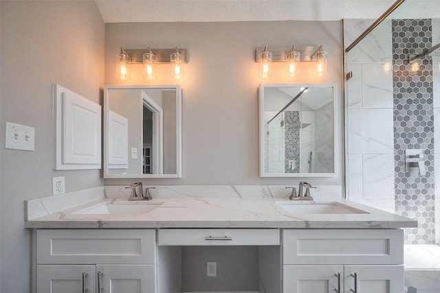 full bathroom with a stall shower, a sink, and double vanity