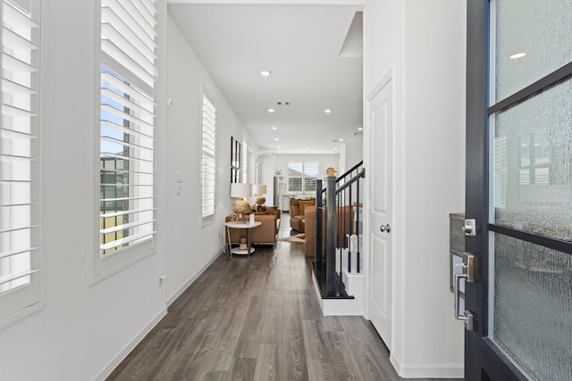 entryway with stairway, baseboards, visible vents, recessed lighting, and dark wood-type flooring