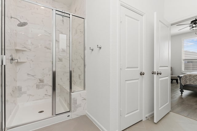 ensuite bathroom featuring a marble finish shower, tile patterned flooring, ensuite bathroom, and baseboards