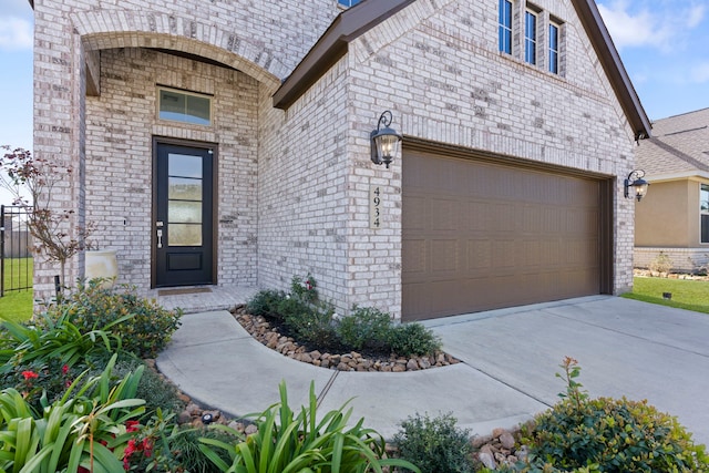 entrance to property with brick siding and driveway