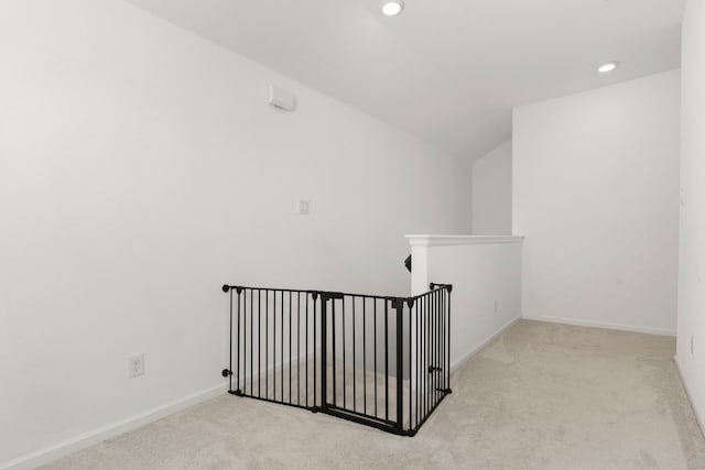 hall with an upstairs landing, recessed lighting, baseboards, and carpet floors