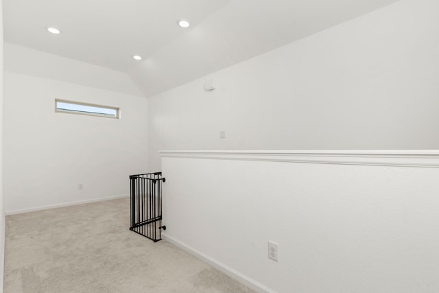 carpeted spare room featuring recessed lighting, baseboards, and lofted ceiling