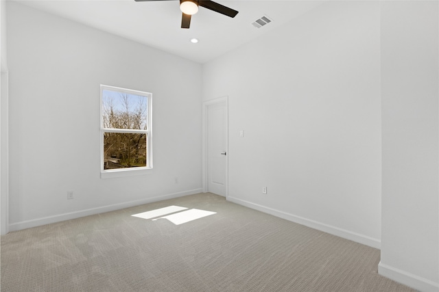 unfurnished room featuring recessed lighting, light colored carpet, a ceiling fan, baseboards, and visible vents