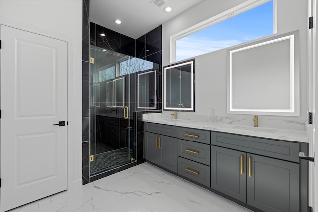 full bathroom featuring recessed lighting, a sink, marble finish floor, a shower stall, and double vanity