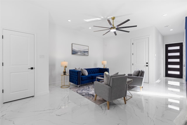 living area with baseboards, marble finish floor, and recessed lighting