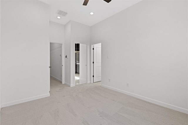 empty room featuring recessed lighting, light colored carpet, a ceiling fan, baseboards, and visible vents