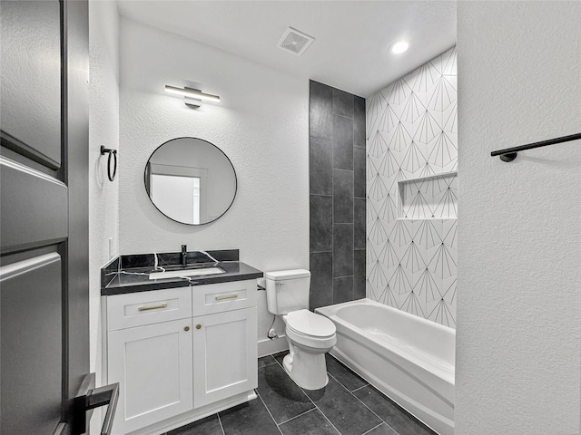 bathroom featuring visible vents, a textured wall, vanity, and toilet