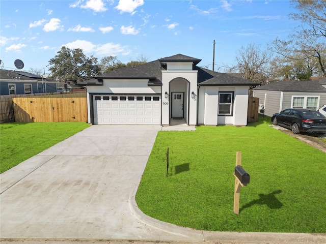 prairie-style house with concrete driveway, an attached garage, fence, a front yard, and stucco siding