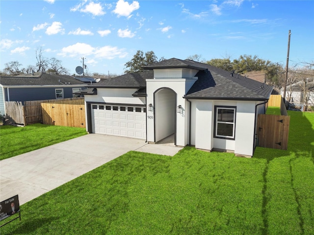 view of front of home with a garage, fence, concrete driveway, stucco siding, and a front yard