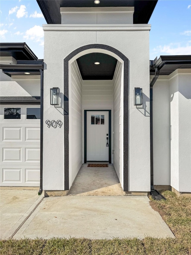 entrance to property featuring stucco siding