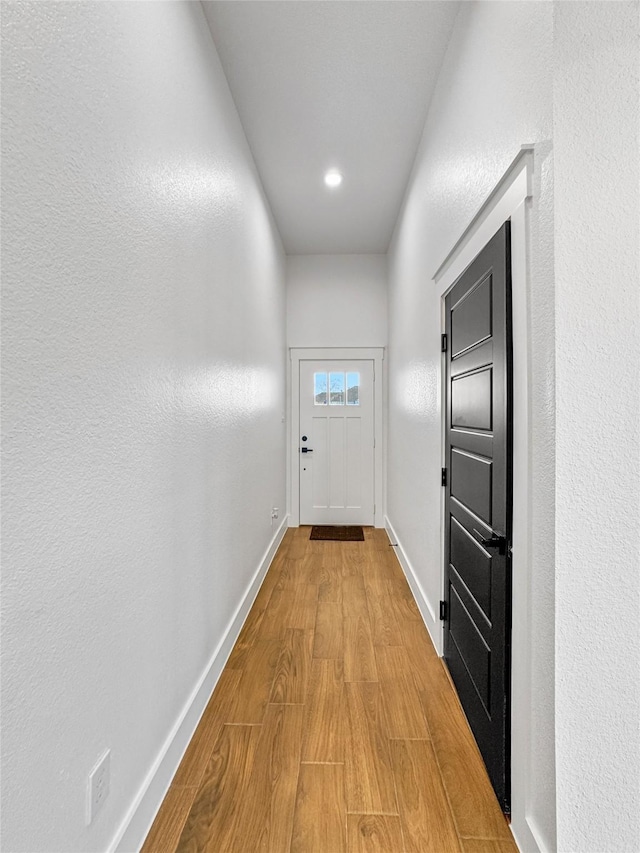 entryway featuring wood finished floors and baseboards