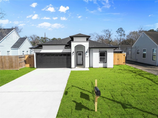 view of front of home featuring a garage, driveway, a front lawn, and fence