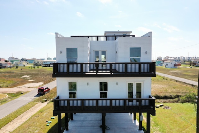 back of property with a yard and french doors