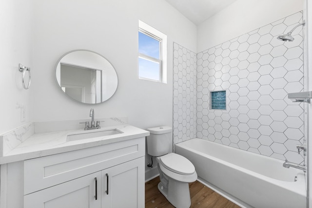 bathroom featuring toilet, washtub / shower combination, wood finished floors, and vanity