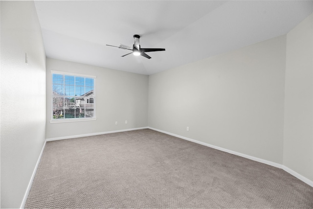 unfurnished room with carpet flooring, ceiling fan, and baseboards