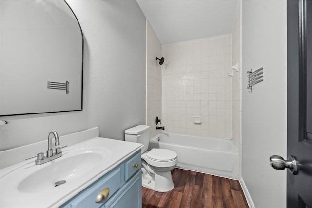 full bathroom featuring tub / shower combination, vanity, toilet, and wood finished floors