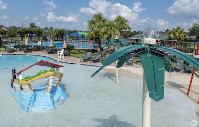 view of pool featuring fence