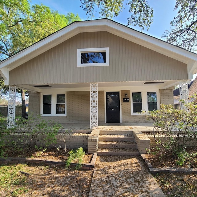 view of front of property with a porch and brick siding