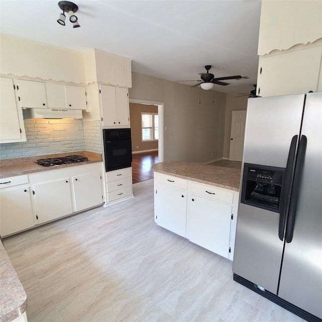 kitchen featuring gas stovetop, decorative backsplash, oven, under cabinet range hood, and stainless steel fridge with ice dispenser