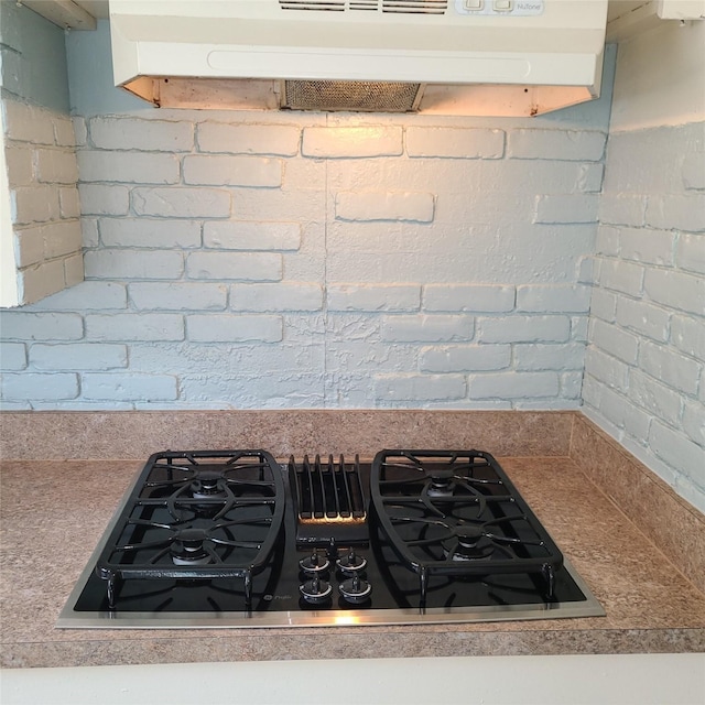 details with stovetop with downdraft and under cabinet range hood