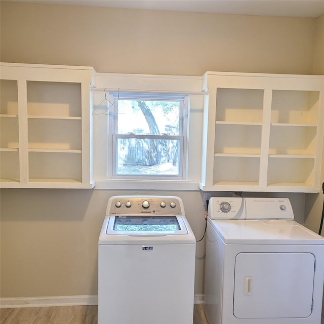 laundry area featuring laundry area, baseboards, and washer and clothes dryer