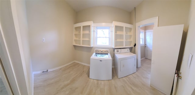 clothes washing area featuring laundry area, light wood finished floors, independent washer and dryer, and baseboards