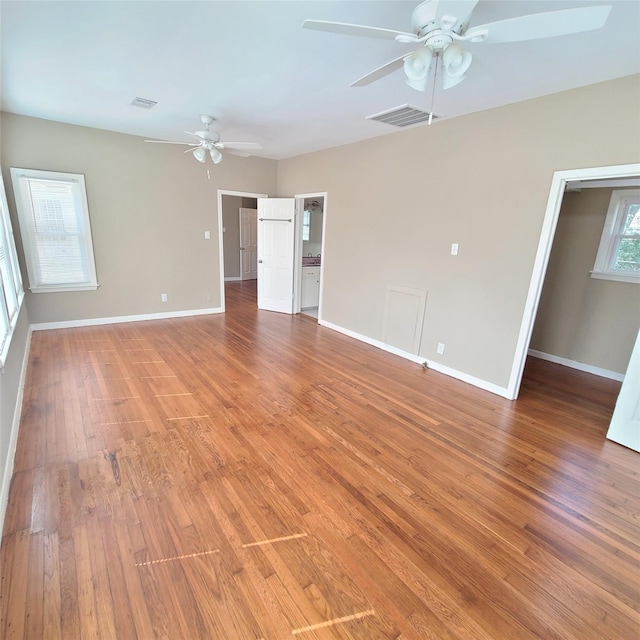 spare room with baseboards, ceiling fan, visible vents, and light wood-style floors