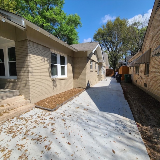 view of side of property with brick siding