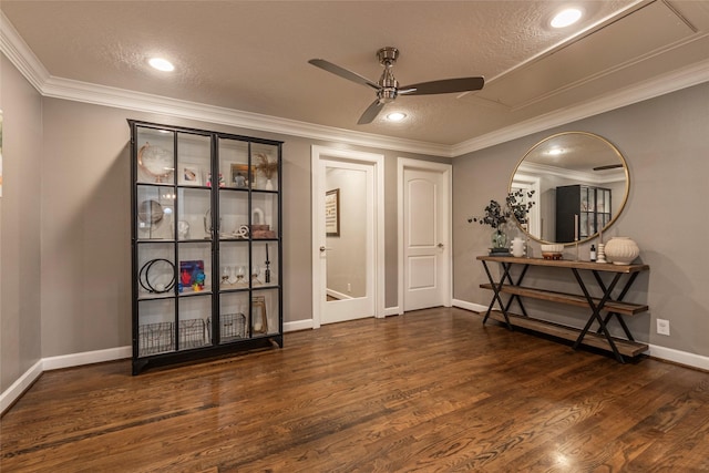 interior space featuring ornamental molding, ceiling fan, a textured ceiling, and wood finished floors