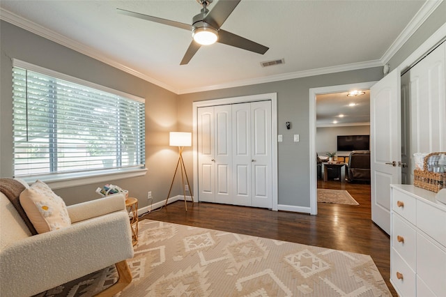 sitting room with crown molding, visible vents, baseboards, and wood finished floors