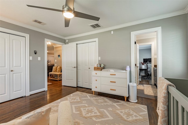 bedroom featuring wood finished floors, visible vents, and crown molding