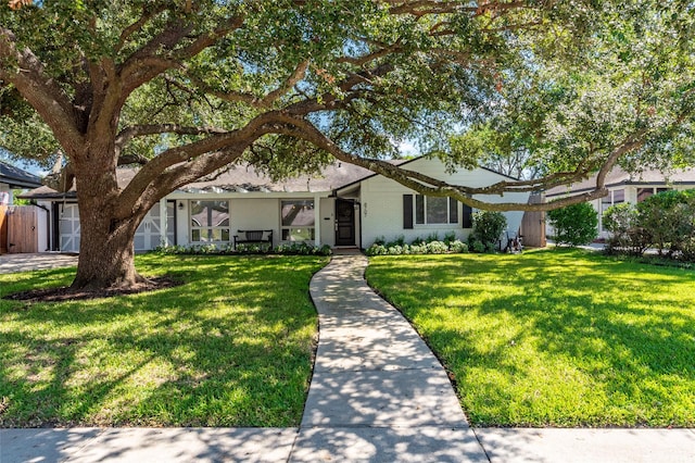 ranch-style house with a front lawn and brick siding