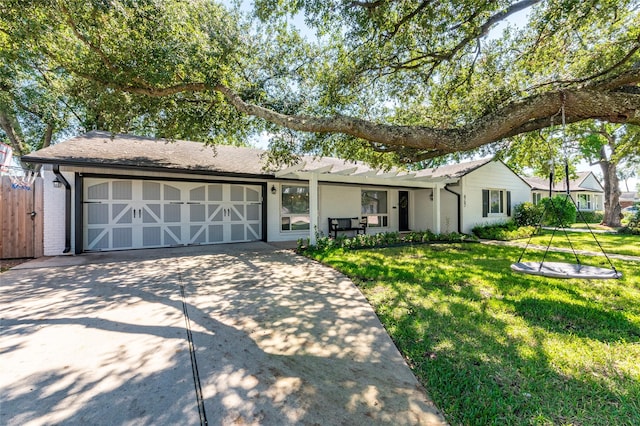 ranch-style home featuring concrete driveway, brick siding, an attached garage, and a front yard