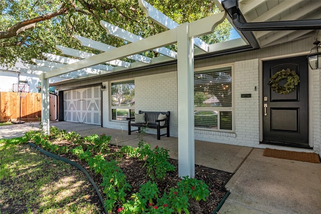 entrance to property with brick siding, fence, a patio, and a pergola